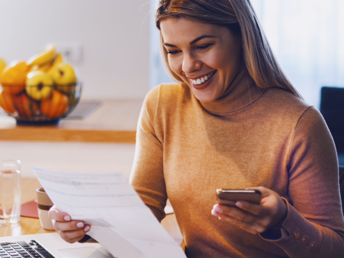 woman with mobile phone reviewing savings account statement with flexible options and single point of contact sterling banker