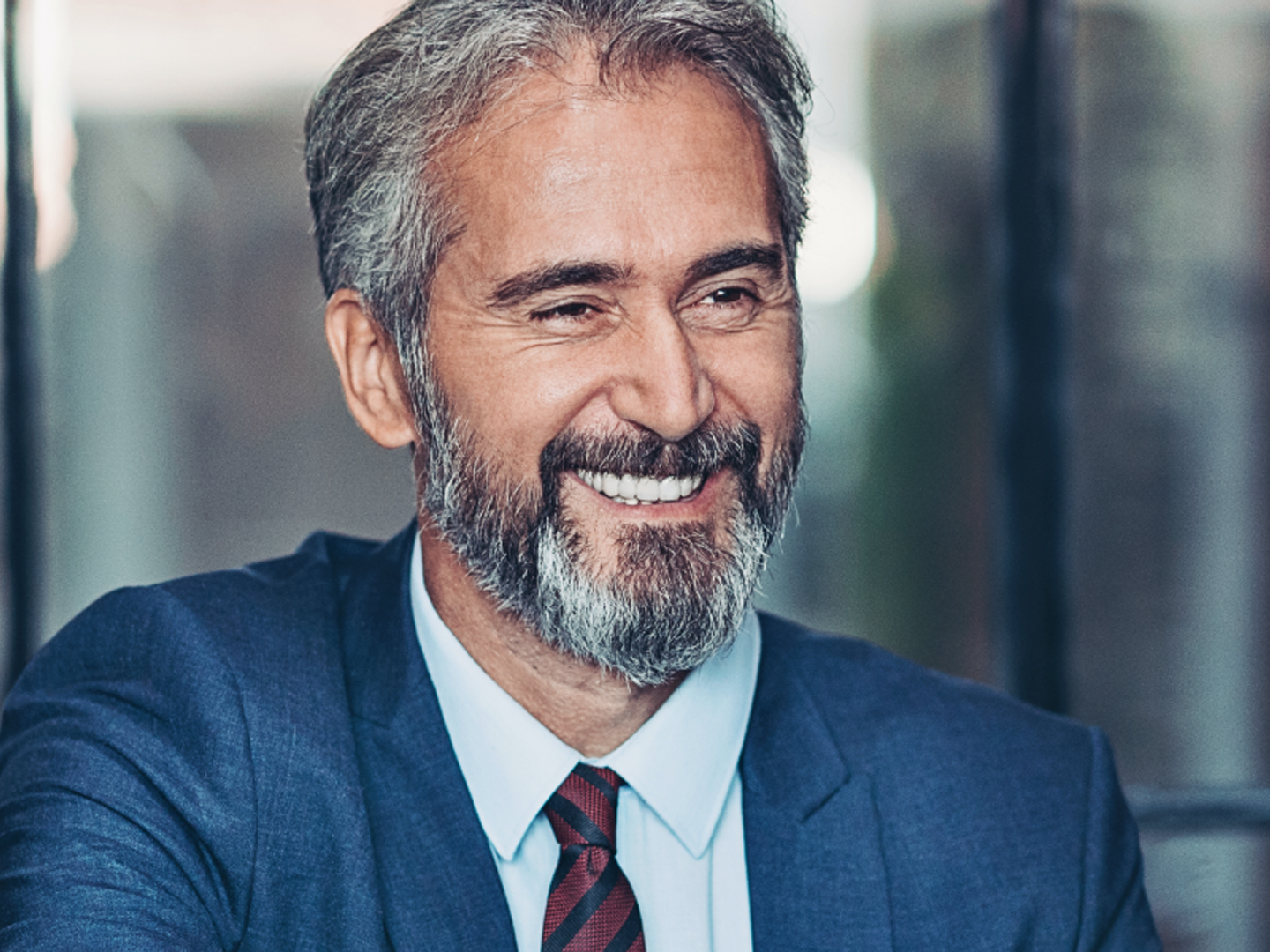 man in business attire smiling