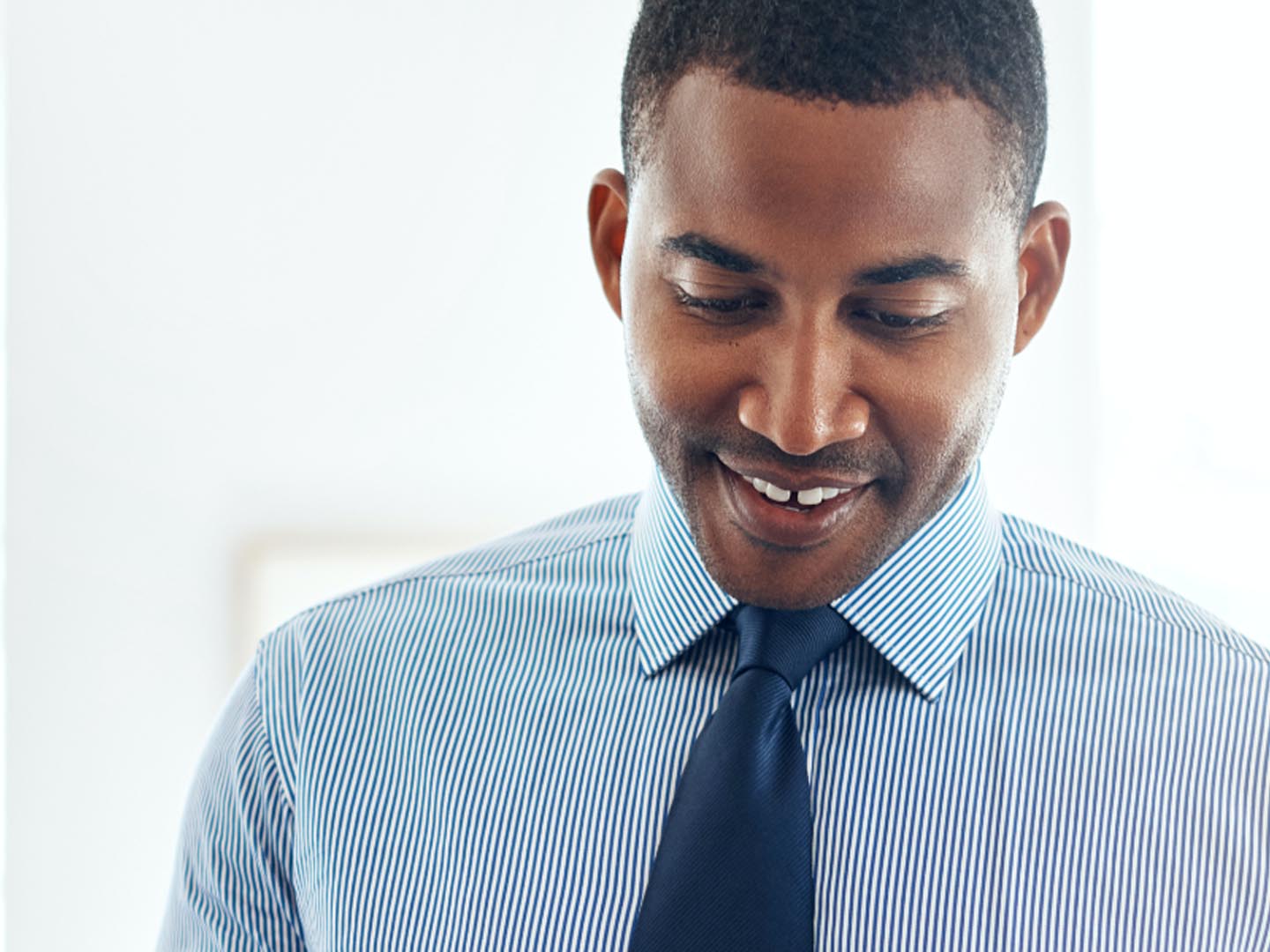 Man wearing collar shirt and tie.