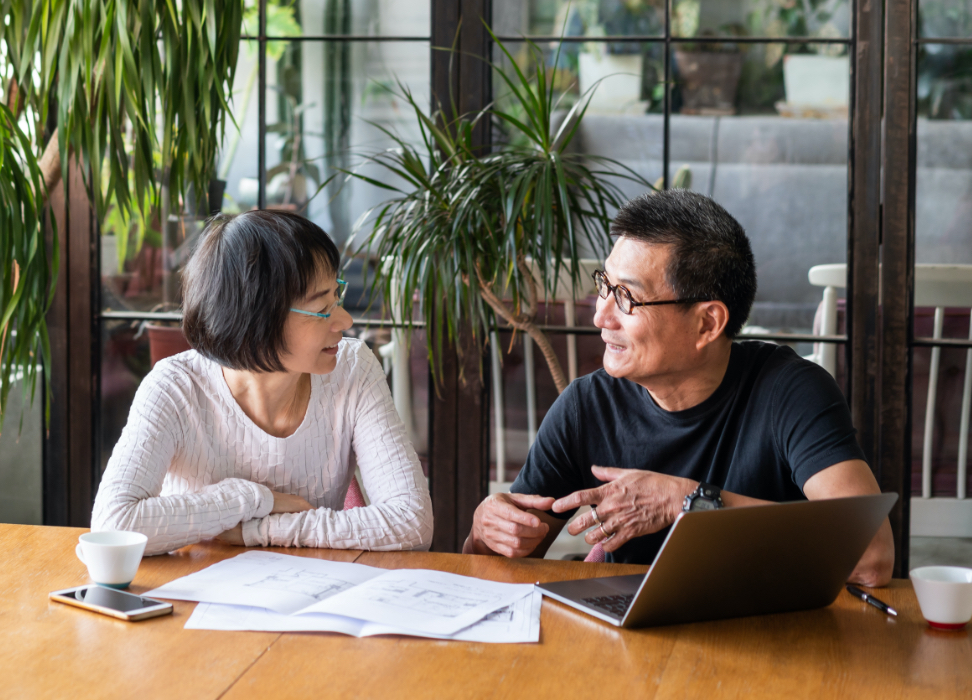 Man and woman sitting at table talking to each other