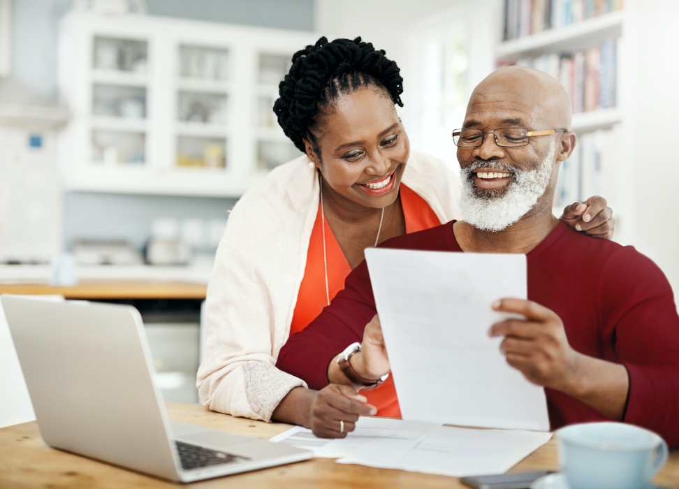 Bald man with beard and woman looking at paper