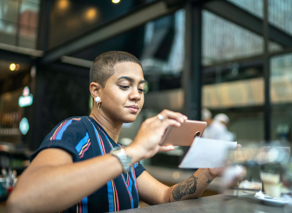 woman depositing check with mobile app phone into sterling checking account