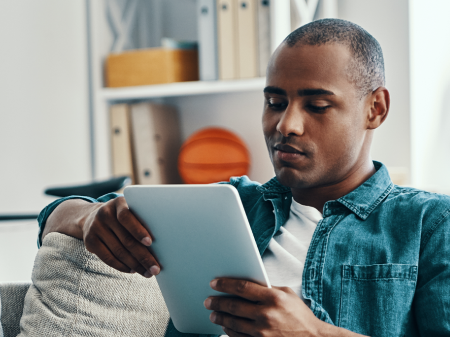 Man sitting down looking at tablet