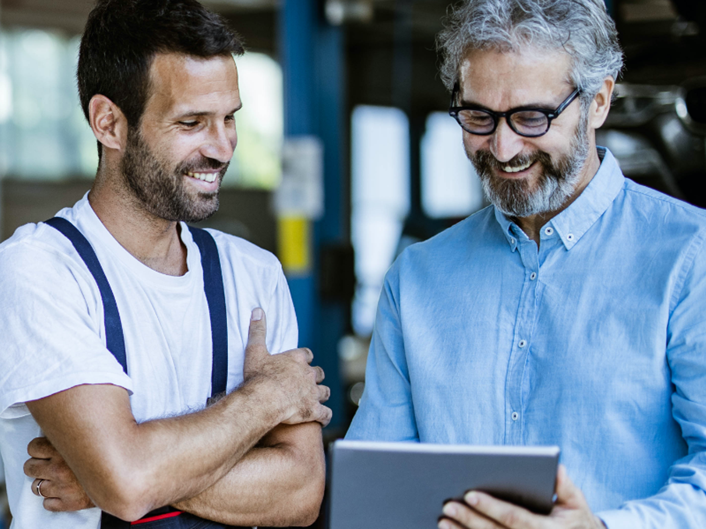 Two men looking at tablet.