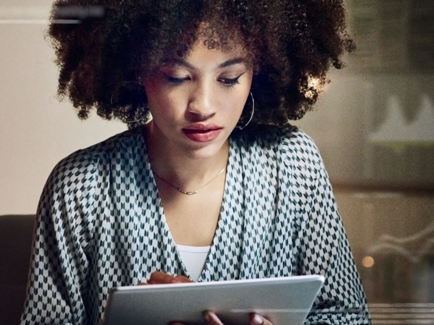 Woman looking at tablet.