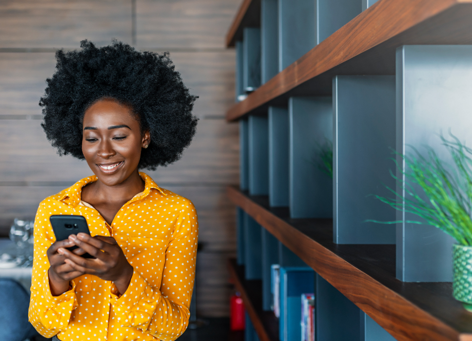 woman smiling at mobile phone