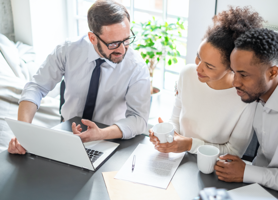 Webster Bank associate consulting man and woman about life insurance while drinking coffee.