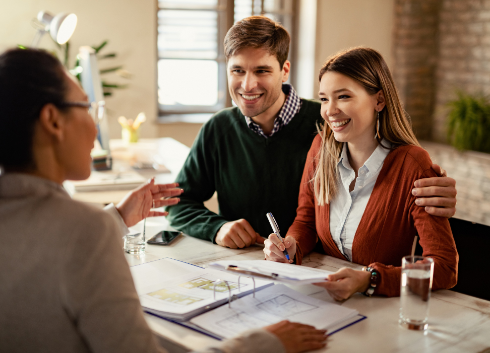 Young man and woman discussing life insurance with Webster Bank associate.