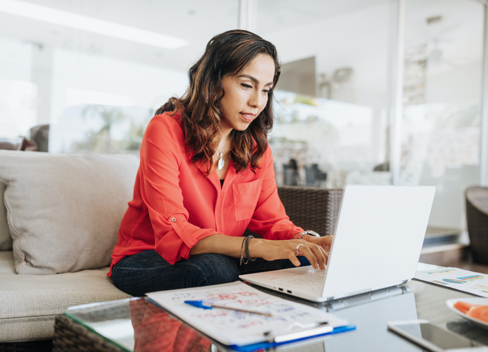 Woman sitting at table with laptop.