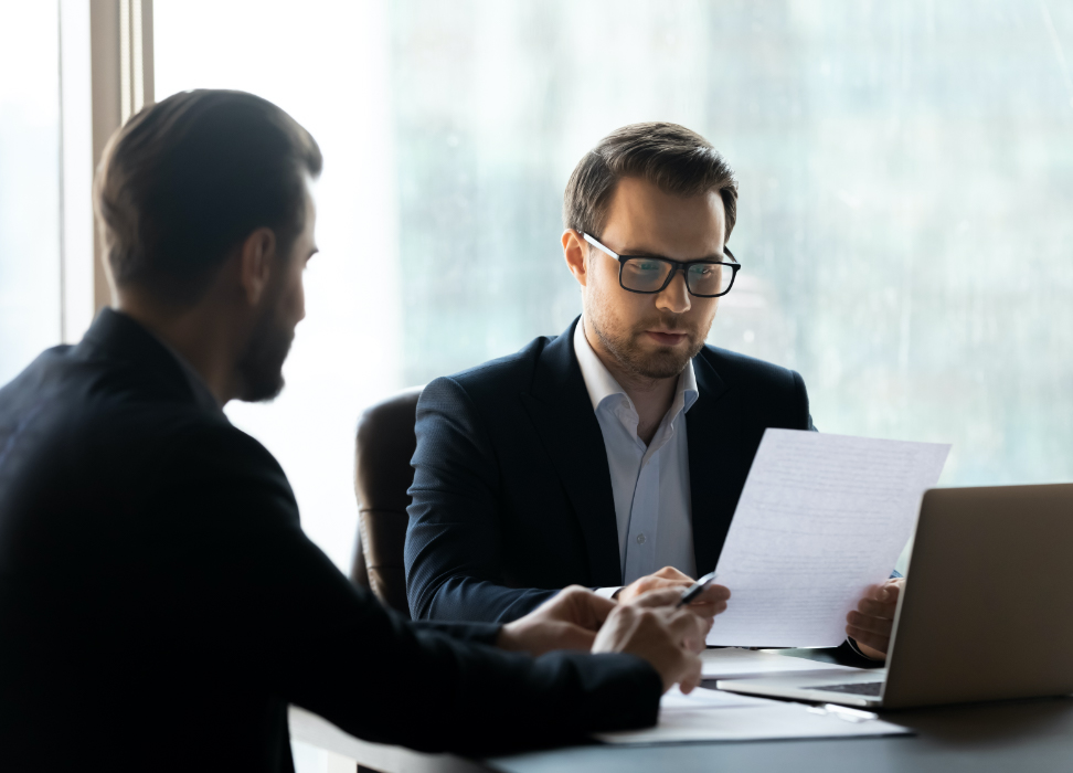 Two people looking at financial papers