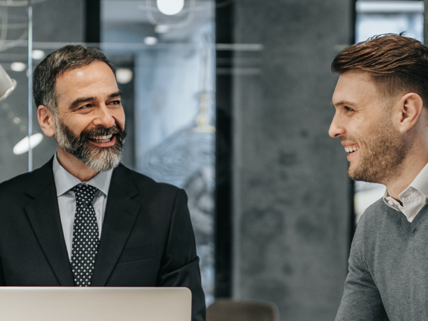 Two people smiling and discussing life insurance products LPL Financial Webster Investments Advisors