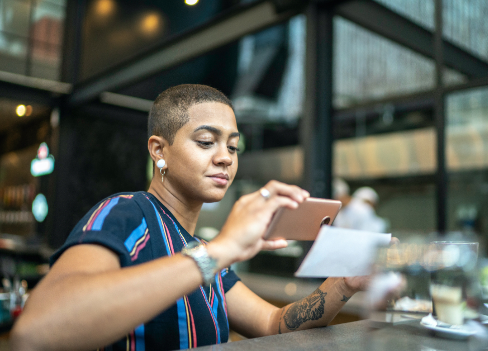 Woman depositing check with mobile device