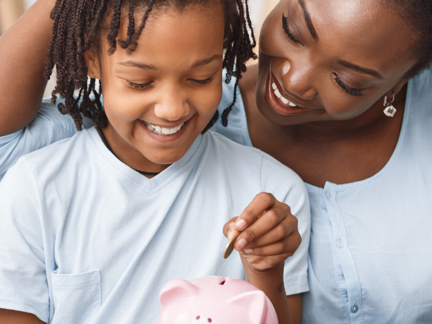 woman and child depositing coins in pink piggy bank representing Sterling Personal Savings