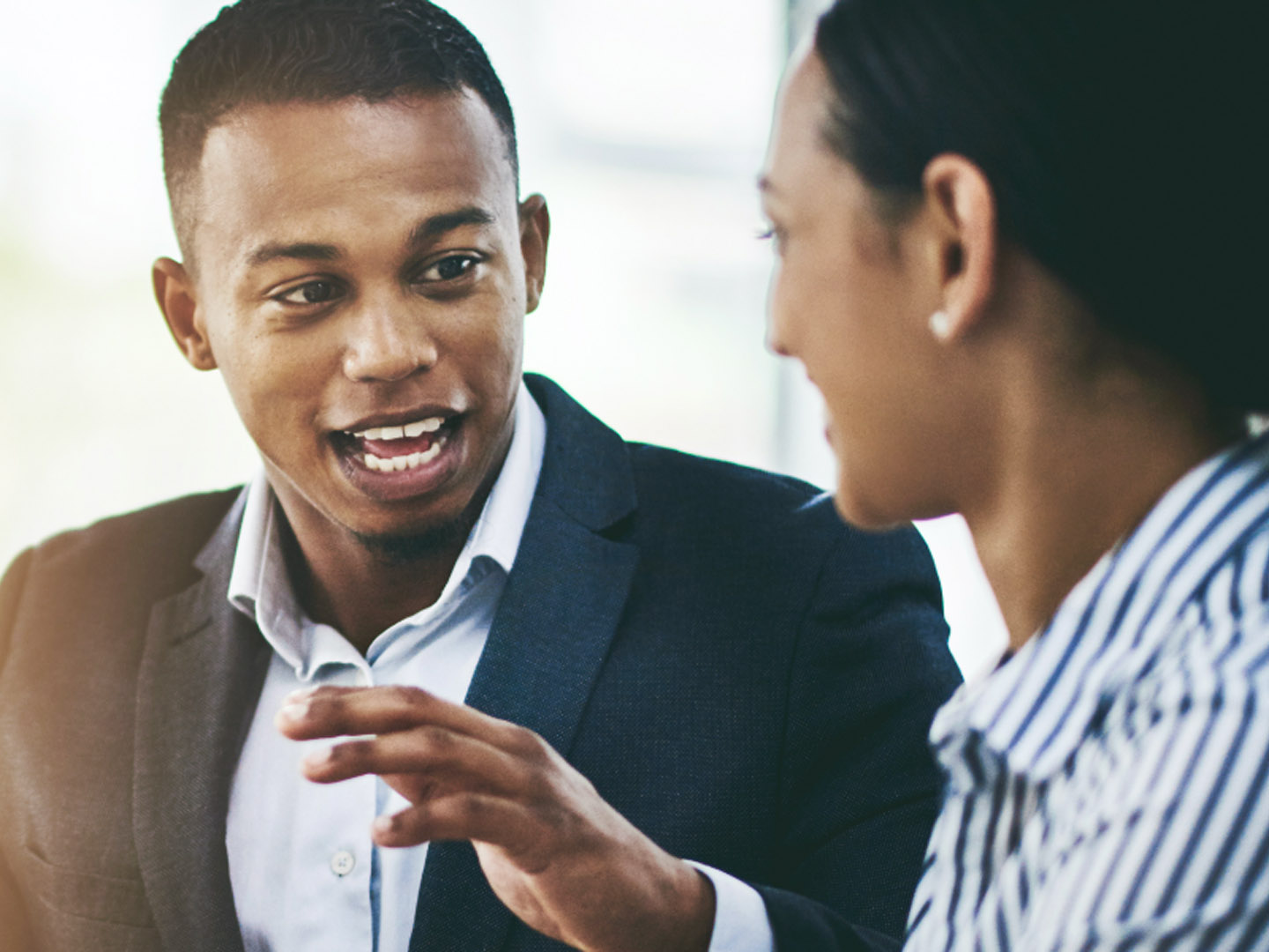 Man and woman talking in office.