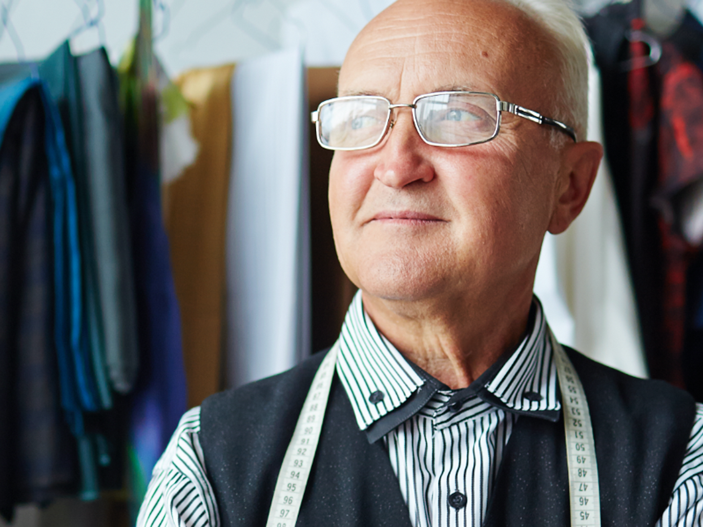 Man with measuring tape draped around neck.