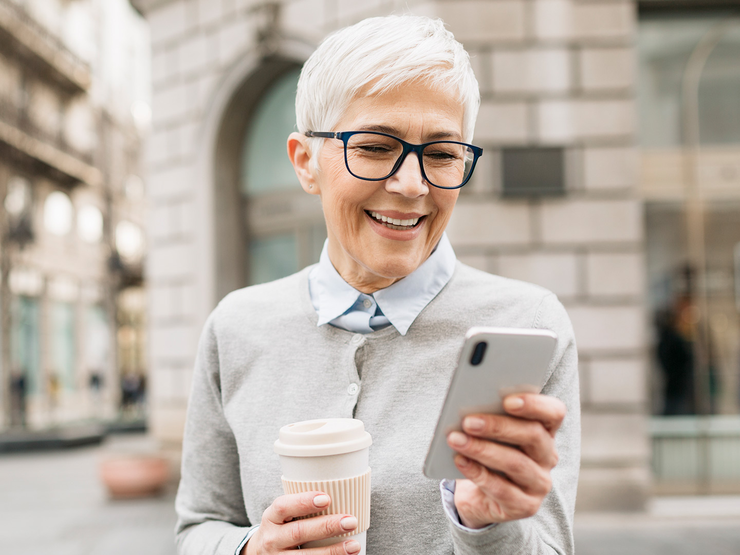 older woman using personal bill pay on mobile device