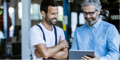 two men looking at tablet reviewing commercial banking