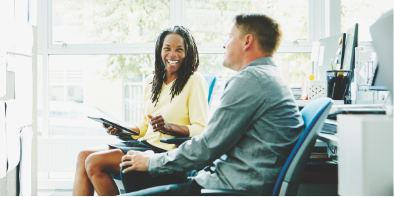 man and woman sitting speaking about business banking