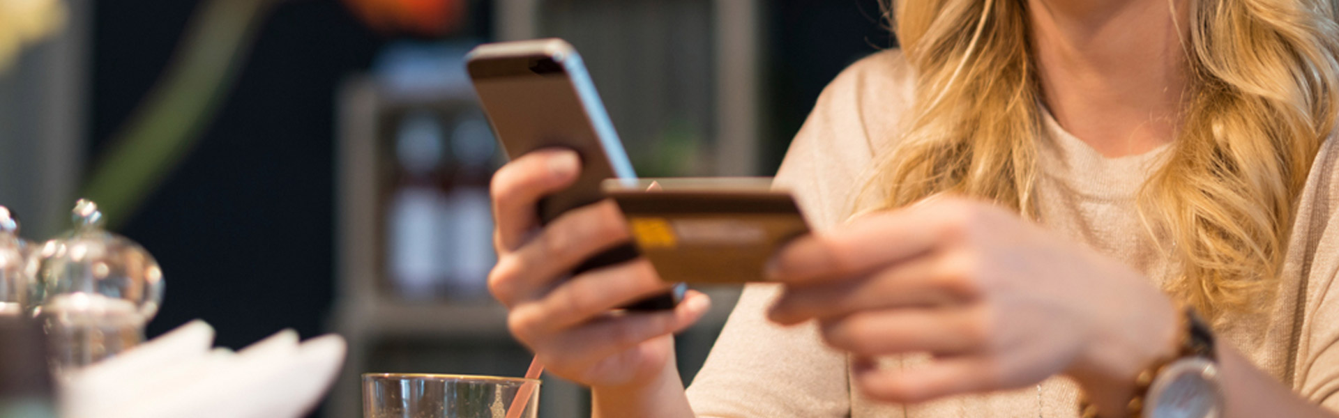 woman using app on phone to unlock debit card