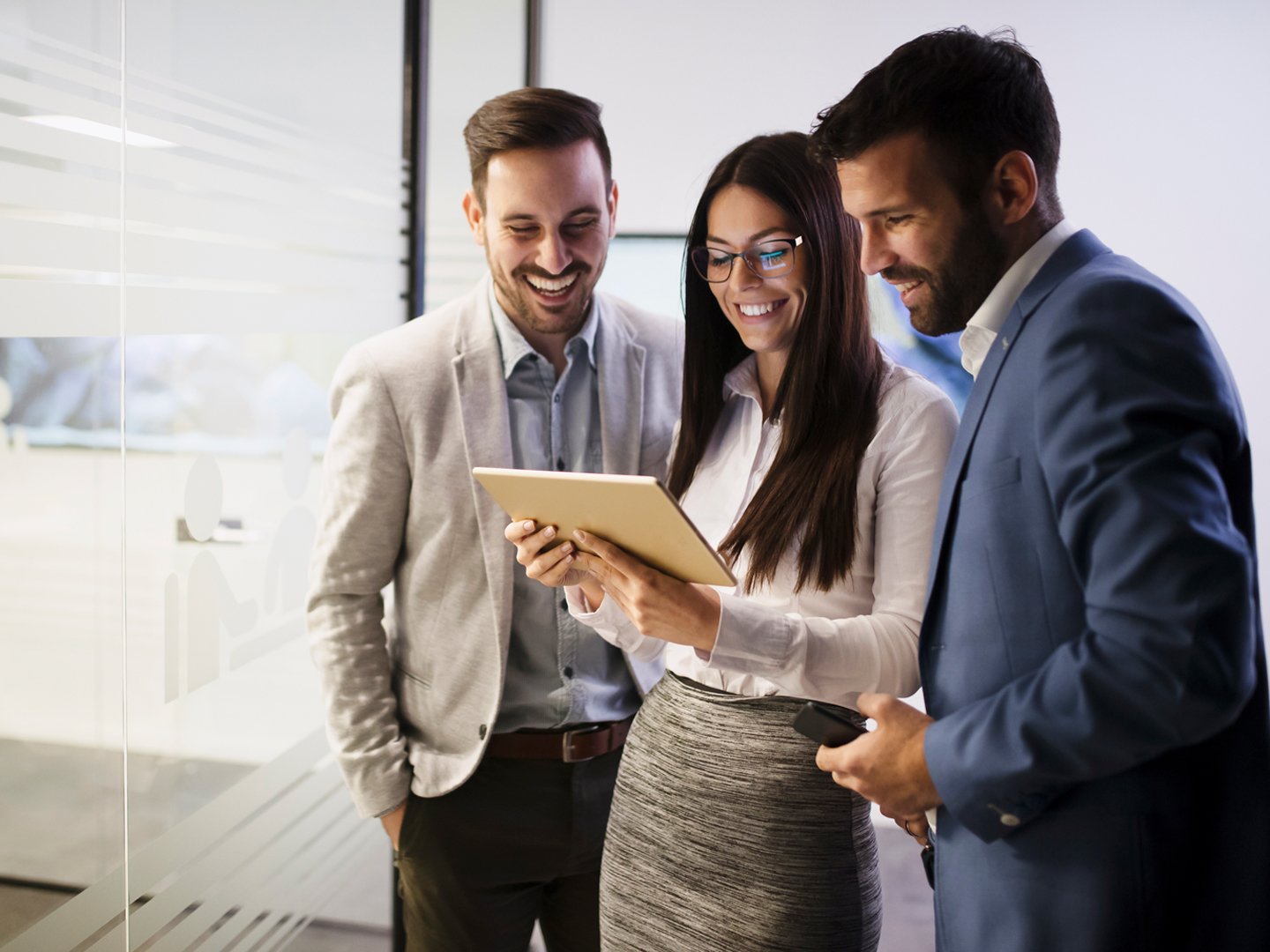 group of business people looking at a tablet