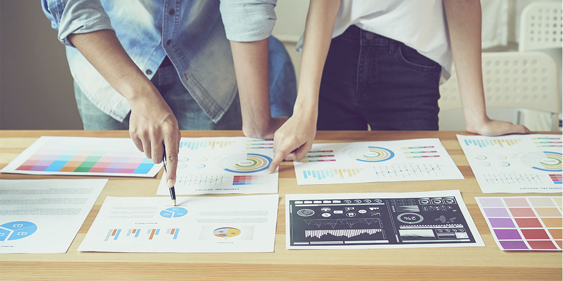 business people looking at financial reports on office desk