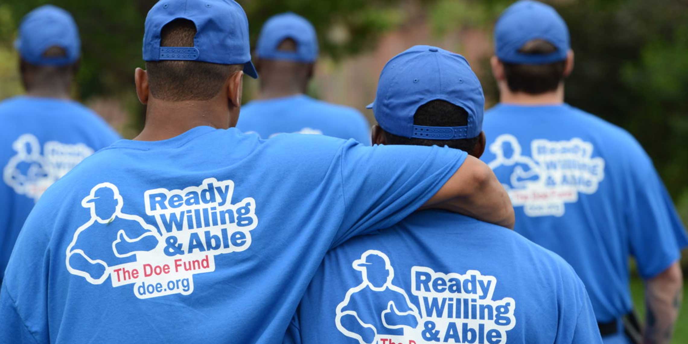 group of people wearing Ready Willing & Able - The Doe Fund tee shirts