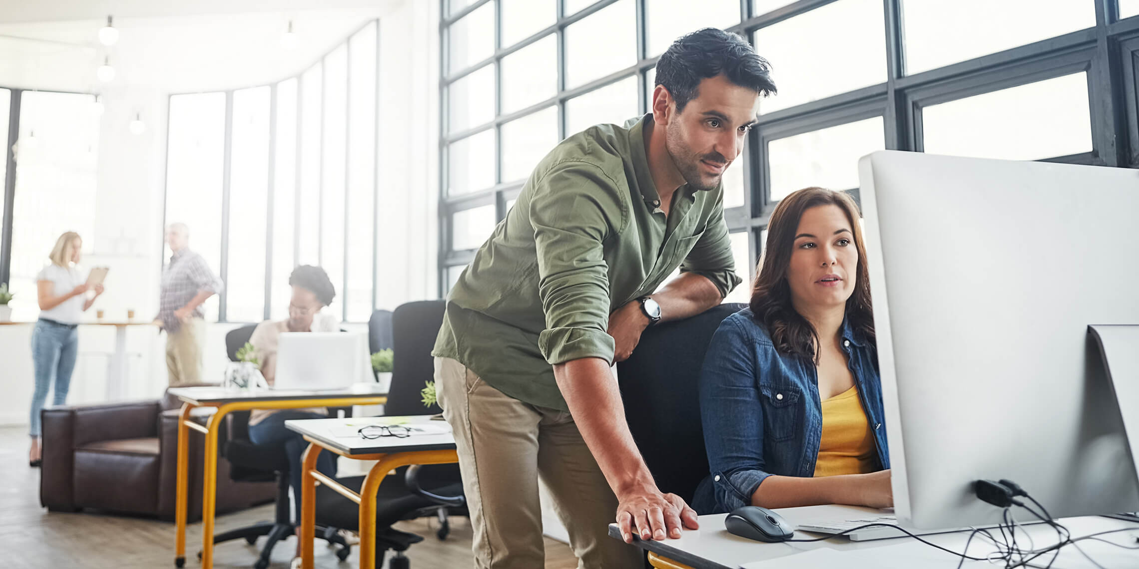 Man and woman on computer in office