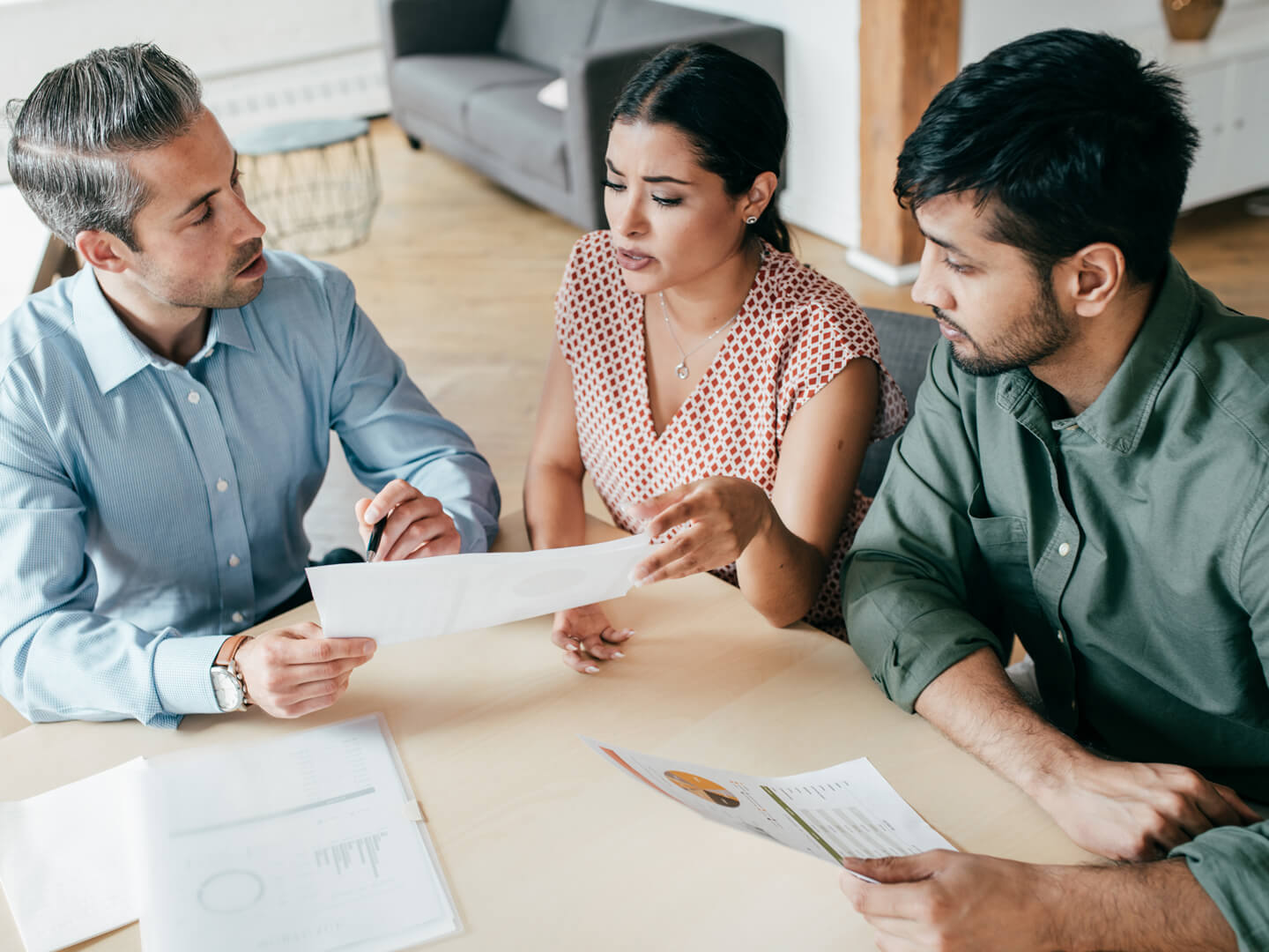 couple reviewing financial paperwork with mortgage banker