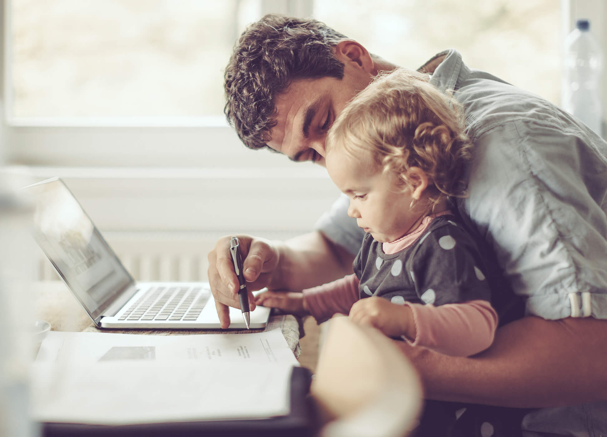 Father showing his daughter hsa account on a laptop