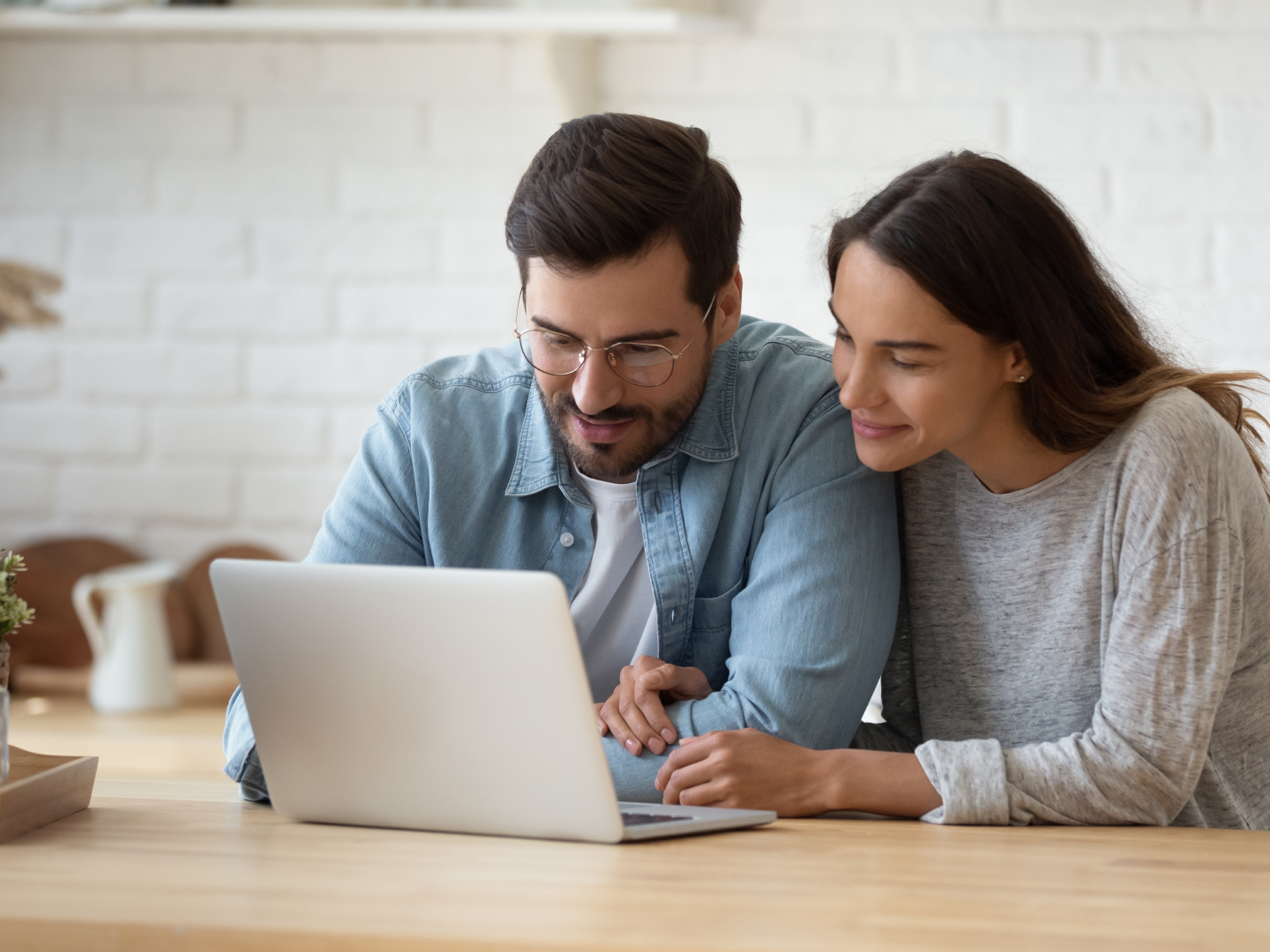 couple looking over finances on a laptop