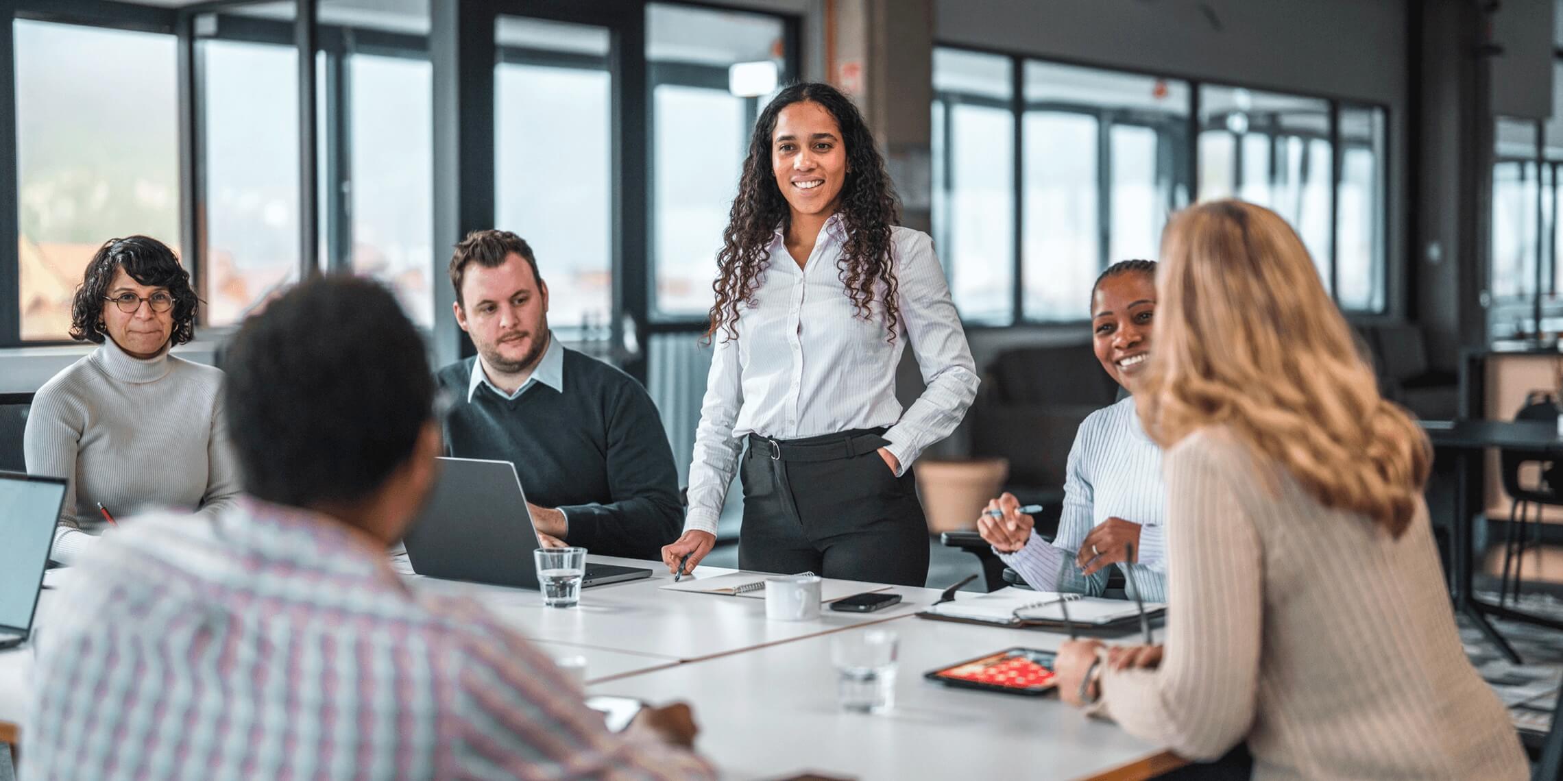 group of business people meeting around conference room table