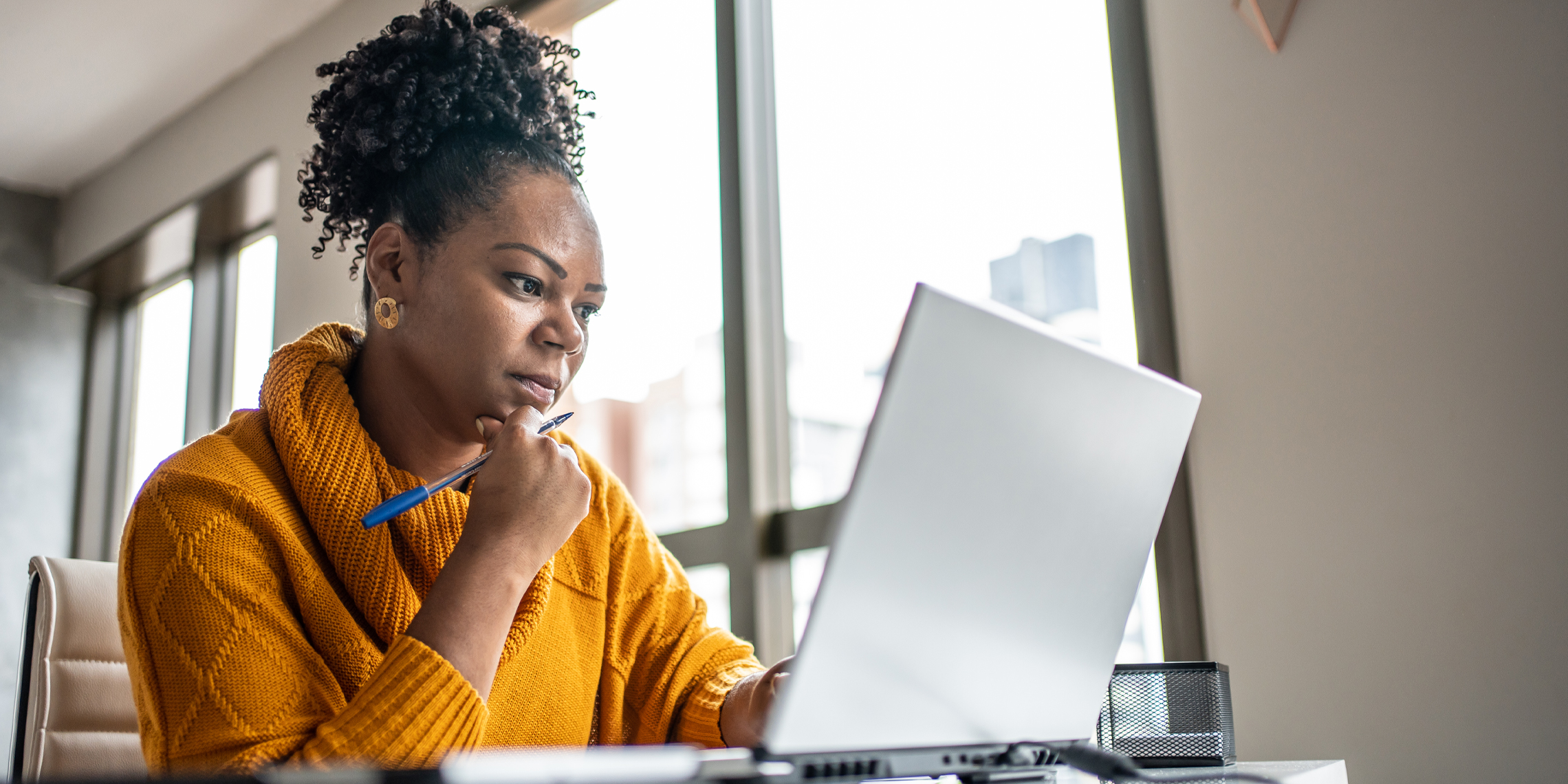 woman looking at laptop.