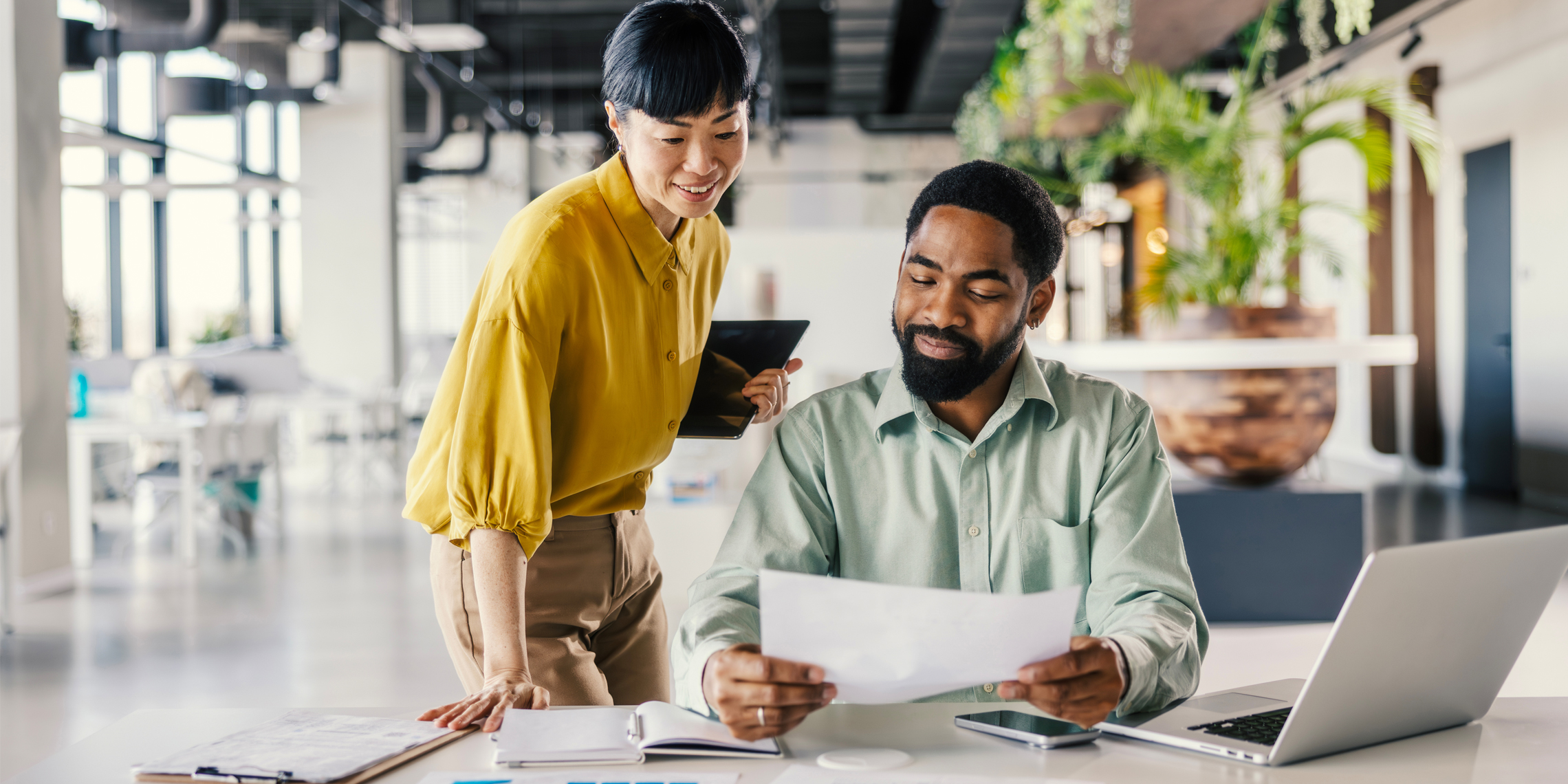 man and woman reviewing a document.
